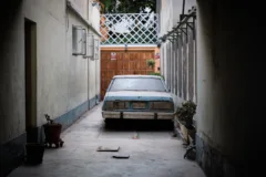 An old car parked down a side street in San Isidro, Lima, Peru.