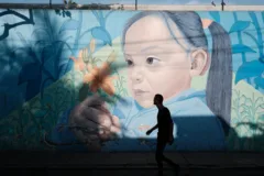 Street art in Lima. Shows a young girl holding flowers.