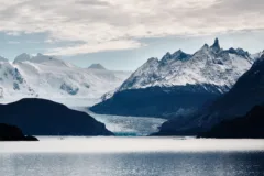 Views across Grey Lake to Grey Glacier in Torres del Paine National Park, Chile. Snow covered mountains can be seen in the background.