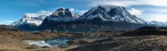 A turquoise lake, backed by snow-capped mountains in Torres del Paine National Park, Chile.