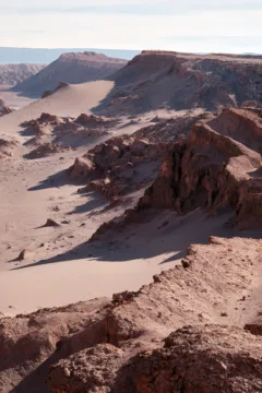 Rocky ridges and sand dunes in the Valley of the Moon, Atacama Desert, Chile.