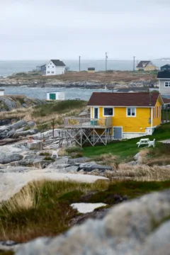 A bright yellow wooden building in a small fishing village.