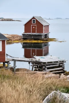 Small red wood building used for fishing in Tilting, Fogo.