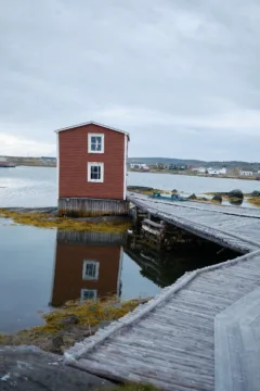 Small red wood building used for fishing in Tilting, Fogo.