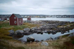 Small red wood building used for fishing in Tilting, Fogo.