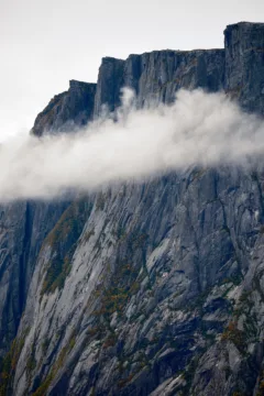 mist hanging below jagged cliffs