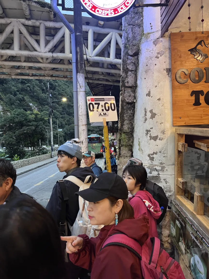 A line of people waiting for the bus to Machu Picchu.