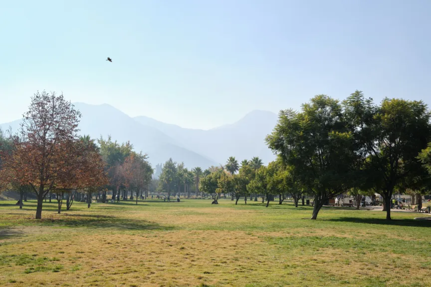 A green lawn with mountains in the background at Parque Bicentenario, Santiago, Chile.