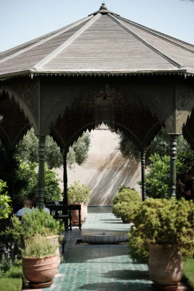 A covered seating area with a tiled pathway running through it.