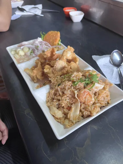 A plate of ceviche, chicharron and seafood fried rice.