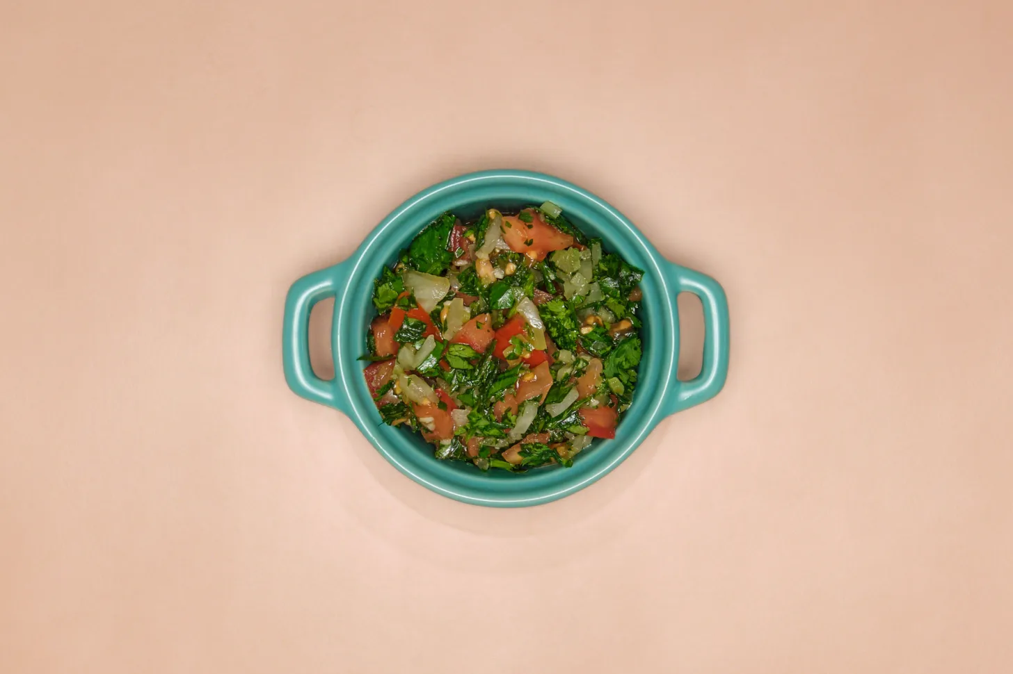 A blue dish full of pebre, a fresh Chilean salsa.