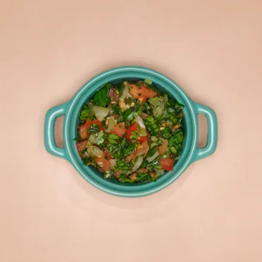 A blue dish full of pebre, a fresh Chilean salsa.