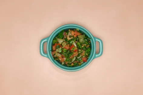 A blue dish full of pebre, a fresh Chilean salsa.