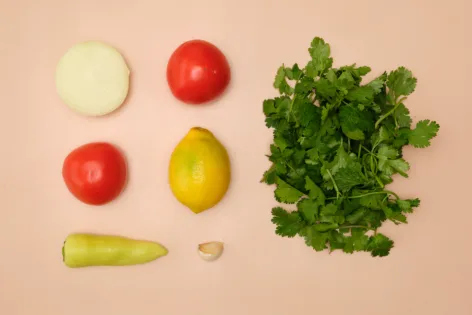 A flat lay of the ingredients needed to make pebre, a fresh Chilean salsa.