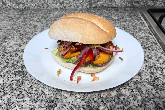 A Peruvian Breakfast sandwich on a white plate.