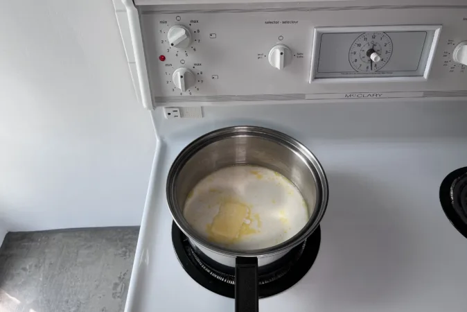 A pan of butter and cream on a hob.