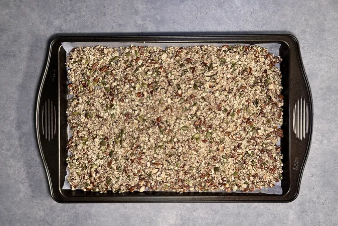 Ingredients for Maple Nut Granola on a baking tray.