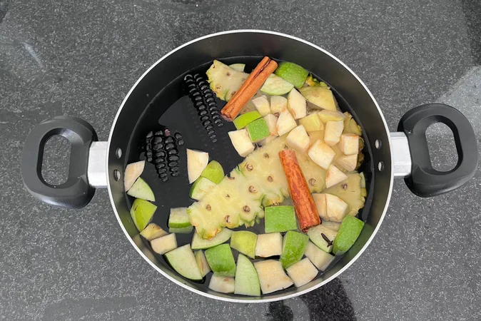 Overhead view of chopped Chicha Morada ingredients in a saucepan.