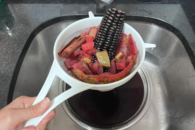 Chicha Morada ingredients being strained through a sieve.