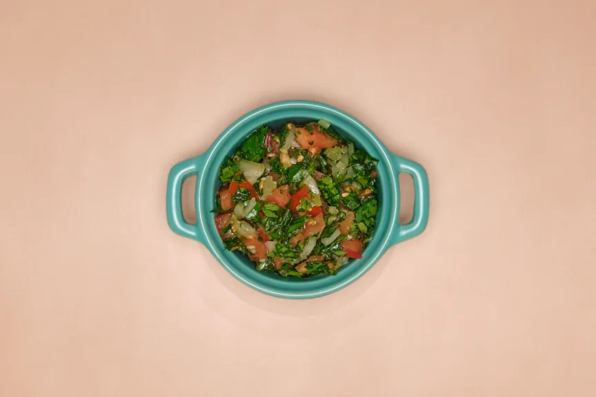 A blue dish full of pebre, a fresh Chilean salsa.