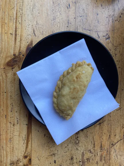 A fried empanada on a plate.